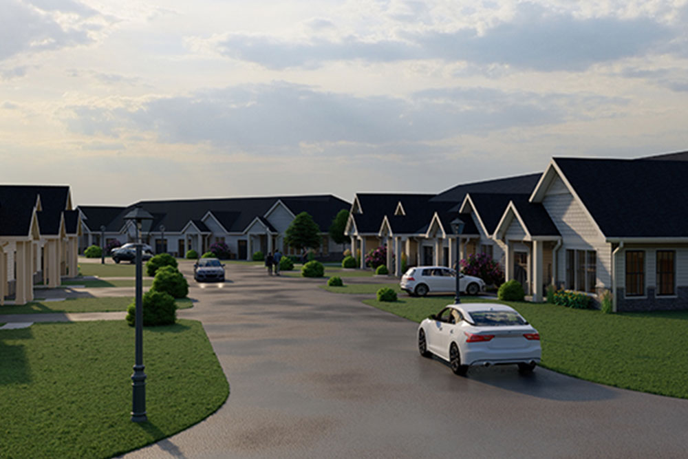 A suburban residential street in Illinois with several single-story homes, neatly trimmed lawns, and parked cars. A white car is driving down the street under a partly cloudy sky, reflecting the peaceful charm often sought by senior living communities.